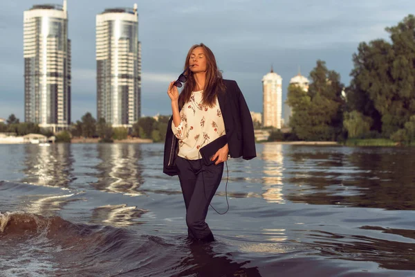 Tanned woman in the city on the coast