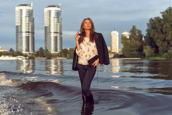 Tanned woman in the city on the coast