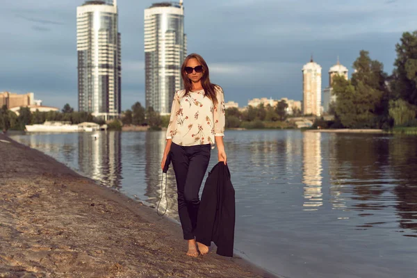 Tanned woman in the city on the coast