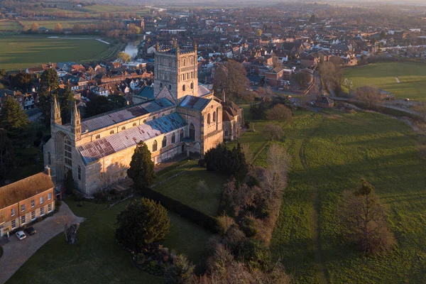 Tewkesbury Abbey 'nin insansız hava aracı bakış açısı gün doğumunda havadan çekilmiş. Muhteşem Manastır 'ı ele geçirmek için Ortaçağ pazar kasabası Tewkesbury' de sabahın erken saatlerinde bir uçuş.