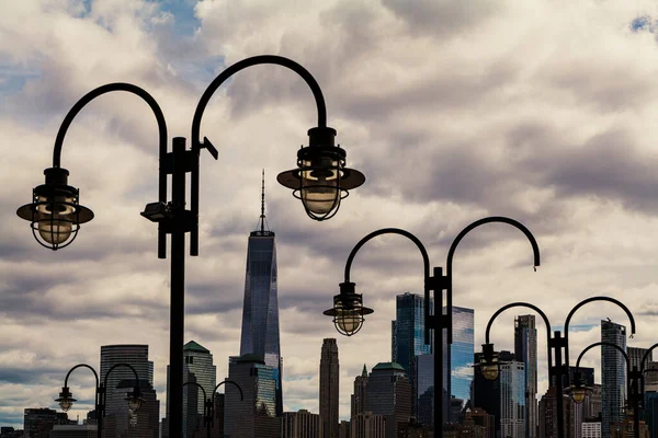 Broken street lamps on the background of the New York City and cloudy sky. High-quality photo