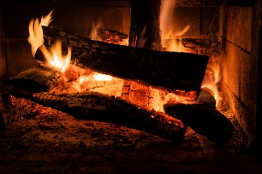 Brick Fireplace in garden. Design Street Fireplace and built by brick at backyard at home. Concrete stone fireplace to ignite the wood. The view of a backyard fireplace with burning logs and beautiful
