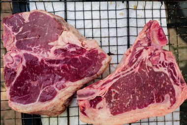 A macro of a wild chanterelle mushroom growing among the moss and grass. The mushroom is smooth on top and has gill like ridges underneath. High quality photo