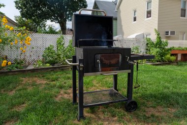 Home barbecue with charcoal in the backyard grilling steaks and other meats. High quality photo