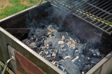 Home barbecue with charcoal in the backyard grilling steaks and other meats. High quality photo