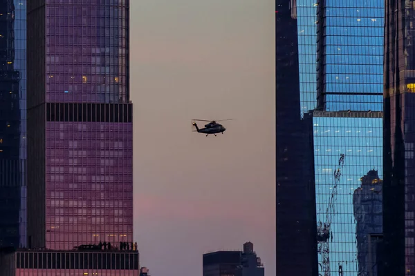 Manhattan skyline Hudson Yards and helicopter on the front, from Weehawken Waterfront in Hudson River at sunset. High quality photo