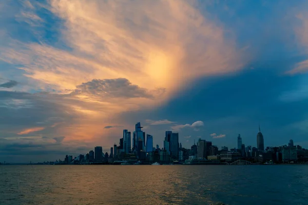 Sunset View to Manhattan skyline Hudson Yards skyscrapers, from Weehawken Waterfront in Hudson River at sunset. High quality photo