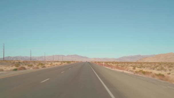 POV driving along empty highway in Nevada Desert on clear day — Stock Video