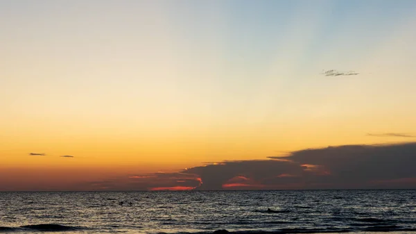 Cielo epico al tramonto con raggi di luce dall'orizzonte sopra l'oceano — Foto Stock