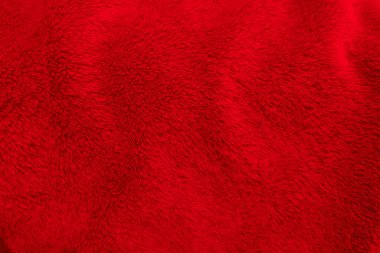 Kırmızı temiz yün dokusu arka planda. hafif doğal koyun yünü. Kırmızı, pürüzsüz pamuk. Tasarımcılar için tüylü kürk dokusu. yakın plan kırmızı yün halı..