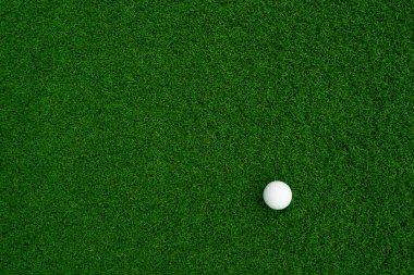 Golf ball close up on green grass on blurred beautiful landscape of golf background.Concept international sport that rely on precision skills for health relaxation.	