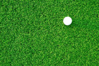 Golf ball close up on green grass on blurred beautiful landscape of golf background.Concept international sport that rely on precision skills for health relaxation.	