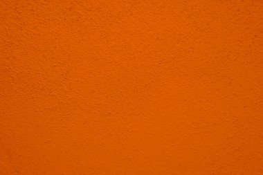 Turuncu beton duvarın pürüzsüz dokusu kaba bir yüzey, metin için alanı, arka plan için alanı var..