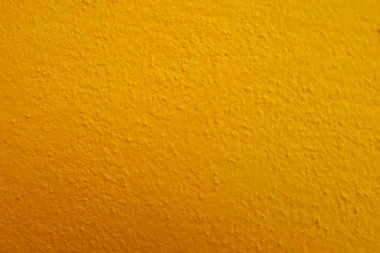Seamless texture of painted yellow cement old wall a rough surface, with space for text, for a background.	