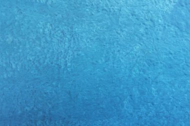 Seamless texture of painted dark blue cement old wall a rough surface, with space for text, for a background.	
