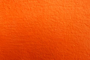Seamless texture of painted orange cement old wall a rough surface, with space for text, for a background.	