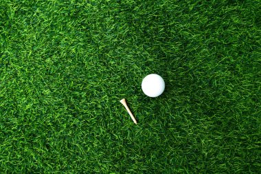 Golf topu, bulanık arka planda yeşil çimlere yakın. Sağlıklı rahatlama için hassas becerilere dayanan uluslararası spor kavramı..