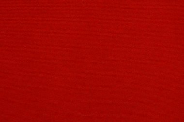 Arka plan olarak kırmızı kadife kumaş dokusu kullanılıyor. Yumuşak ve pürüzsüz tekstil malzemelerinden oluşan boş kırmızı kumaş arka plan. Metin için boşluk var.