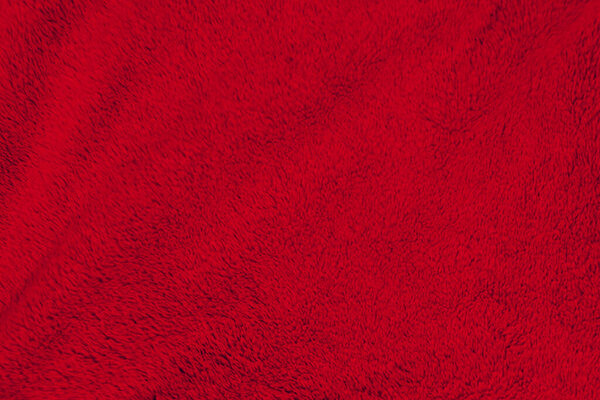 Красная чистая шерсть текстура фона. светлая натуральная овечья шерсть. Красный хлопок без швов. текстура пушистого меха для дизайнеров. Ковровое покрытие из красной шерсти крупным планом..