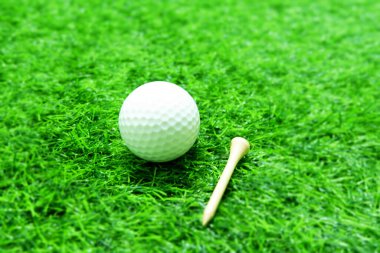 Golf ball close up on green grass on blurred beautiful landscape of golf background.Concept international sport that rely on precision skills for health relaxation.	