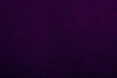 Arka plan olarak kullanılan mor kadife kumaş dokusu. Yumuşak ve pürüzsüz tekstil malzemelerinin boş mor kumaş arkaplanı. Metin için boşluk var.