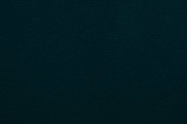 Arka plan olarak kullanılan koyu yeşil kadife kumaş dokusu. Yumuşak ve pürüzsüz tekstil malzemelerinden oluşan boş yeşil kumaş arka planı. Metin için boşluk var..