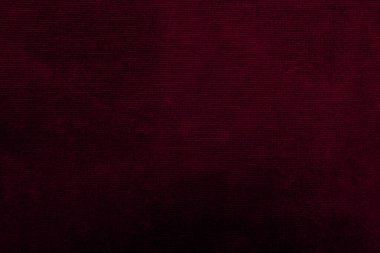 Arka plan olarak kullanılan mor kadife kumaş dokusu. Yumuşak ve pürüzsüz tekstil malzemelerinin boş mor kumaş arkaplanı. Metin için boşluk var...