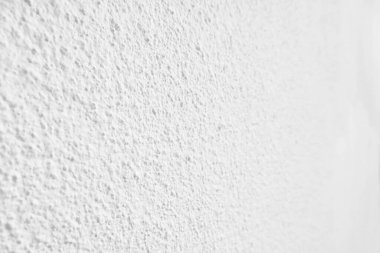Beyaz beton duvarın pürüzsüz dokusu kaba bir yüzey, metin için boşluk, arkaplan için alan.