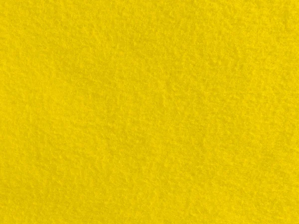 Felt yellow soft rough textile material background texture close up,poker table,tennis ball,table cloth. Empty yellowfabric background..	