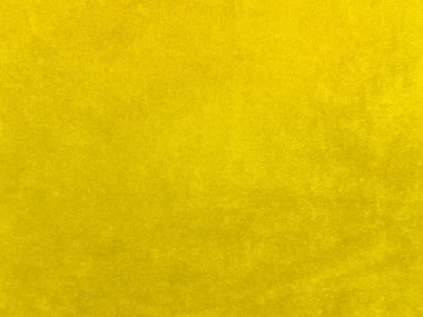 Yellow velvet fabric texture used as background. Empty yellow fabric background of soft and smooth textile material. There is space for text.	
