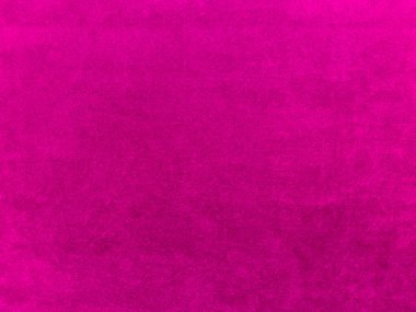 Arka plan olarak kullanılan pembe kadife kumaş dokusu. Yumuşak ve pürüzsüz tekstil malzemelerinin boş pembe kumaş arka planı. Metin için boşluk var.