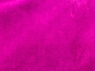 Arka plan olarak kullanılan pembe kadife kumaş dokusu. Yumuşak ve pürüzsüz tekstil malzemelerinin boş pembe kumaş arka planı. Metin için boşluk var.