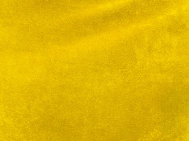 Yellow velvet fabric texture used as background. Empty yellow fabric background of soft and smooth textile material. There is space for text.	