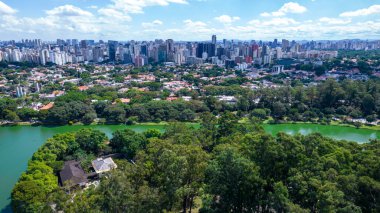 Aerial view of Ibirapuera Park in Sao Paulo, SP. Residential buildings around. Lake in Ibirapuera Park.