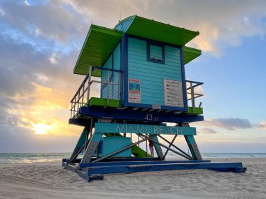 Iconic blue lifeguard house in Miami Beach. Beautiful sky at sunrise.