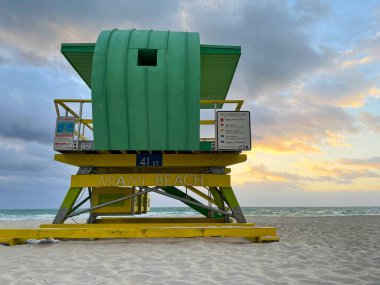 Iconic green lifeguard house in Miami Beach. Beautiful sky at sunrise.
