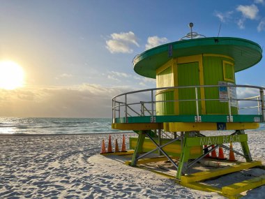 Iconic green lifeguard house in Miami Beach. Beautiful blue sky at sunrise..