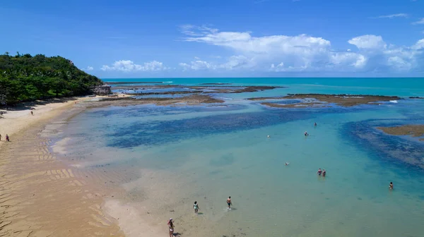 Aerial view of Praia do Espelho, Porto Seguro, Bahia, Brazil. Natural pools in the sea, cliffs and greenish water.
