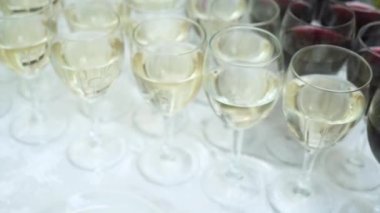 Wine. Row of wine glasses with poured alcohol at party banquet. close-up