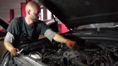 Otomatik tamirci SUV motorunu tamir eder. otomatik tamir istasyonu.