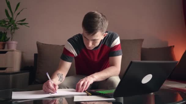 Young Man Works Home Remote Work Filling Out Paperwork — Stock Video