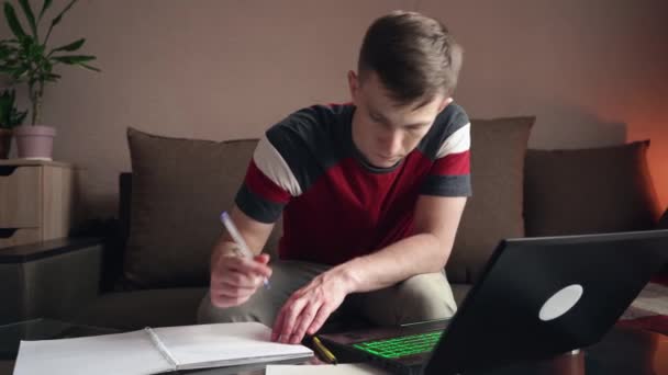 Young Man Works Home Remote Work Filling Out Paperwork — Stock Video