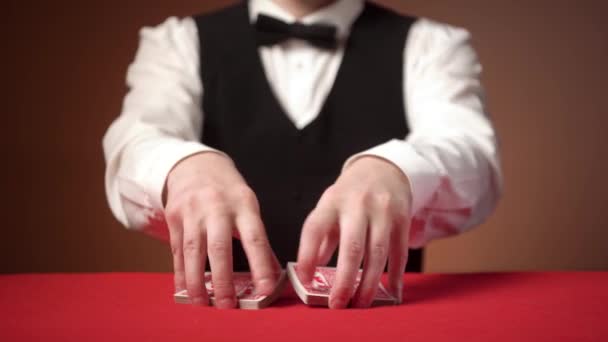 Young Male Croupier Shuffles Cards Start Game Red Table — Stock Video