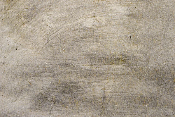 Üzerinde çizikler ve mikro çatlaklar olan sağlam bir beton duvar. Tam çerçeve beton duvar dokusu arkaplanı.