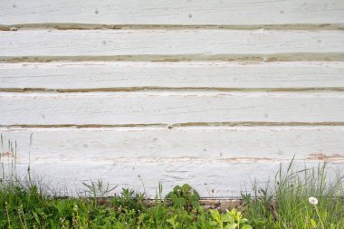 White painted wooden vintage log cabin outside wall, background with  copy space.