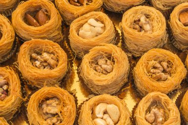 Baklava dessert with roasted pistachio, almond, and cashew nuts made of shredded phyllo dough and shaped into bird nests.