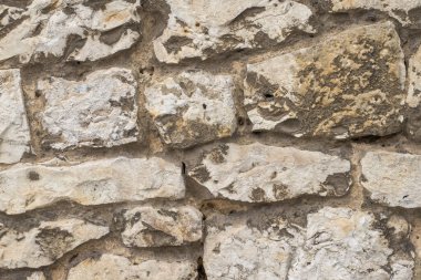 Düzensiz taş bloklardan yapılmış bir duvar. Desenli arkaplan veya pankart.