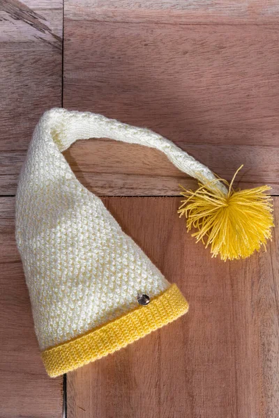 Yellow White Elf Hat Winter Hand Crocheted Orange Wooden Background — Foto de Stock