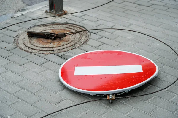 The road sign has fallen. The road sign is broken. Road. No travel. Stop sign. Pedestrian crossing sign. The wind blew off road signs.