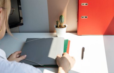 The head of the company opens the documents for signing